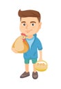 Caucasian boy holding a chicken and hen eggs.