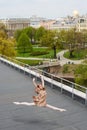 Caucasian fashion ballerina leaping on the roof