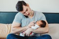 Caucasian father dad with newborn mixed race Asian Chinese baby working from home Royalty Free Stock Photo