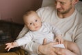 A Caucasian father holds his baby son in his arms. Happy fatherhood and family Royalty Free Stock Photo