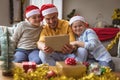 Caucasian father and two sons having a video call on digital tablet at home during christmas Royalty Free Stock Photo