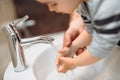 Caucasian father washing child on hands in bathroom at home Royalty Free Stock Photo