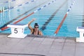 Caucasian female athlete swimmer celebrates victory in a swimming competition Royalty Free Stock Photo