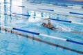 Caucasian female athlete swimmer swimming laps in a pool Royalty Free Stock Photo