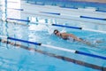 Caucasian female athlete swimmer swimming laps in a pool Royalty Free Stock Photo