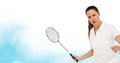 Caucasian female badminton player holding racket against watercolor texture blue background Royalty Free Stock Photo