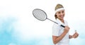 Caucasian female badminton player holding racket smiling against watercolor texture blue background Royalty Free Stock Photo
