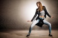 Caucasian female in casual clothaers dancing astraddle Royalty Free Stock Photo