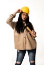 Caucasian female construction worker in a hard hat holding a hammer isolated on a white background. Royalty Free Stock Photo