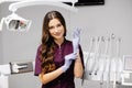 Caucasian female dentist putting on blue sterilized surgical gloves in the medical clinic Royalty Free Stock Photo