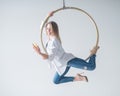 Caucasian female gymnast doing aerial hoop exercises and using smartphone. Royalty Free Stock Photo