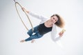 Caucasian female gymnast doing aerial hoop exercises and using smartphone. Royalty Free Stock Photo