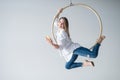 Caucasian female gymnast doing aerial hoop exercises and using smartphone. Royalty Free Stock Photo