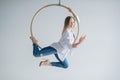 Caucasian female gymnast doing aerial hoop exercises and using smartphone. Royalty Free Stock Photo