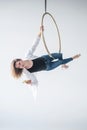 Caucasian female gymnast doing aerial hoop exercises and using smartphone. Royalty Free Stock Photo