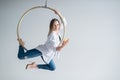 Caucasian female gymnast doing aerial hoop exercises and using smartphone. Royalty Free Stock Photo