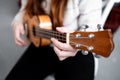 Caucasian female playing ukulele with focus on fingerpicking technique Royalty Free Stock Photo