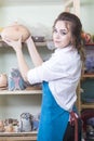 Caucasian Female Potter Holding Big Argil Bowl in Workshop