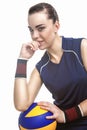 Caucasian Female Professional Volleyball Athlete Sitting and Holding Ball. Over White Background Royalty Free Stock Photo