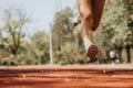 Caucasian female runner sprinting, training outdoors in the park, improving fitness levels for a race.