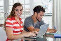 Caucasian female student at computer with latin american guy Royalty Free Stock Photo