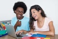 Caucasian female student learning with african american male stu Royalty Free Stock Photo