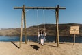 Caucasian female swinging on the sandy of Lagos do Sabor in Miradouro de Sao Lourenco, Portugal