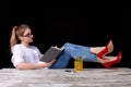 Caucasian female teacher is putting her feet on the table. Royalty Free Stock Photo