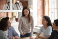 Caucasian female team leader speak at meeting with groupmates