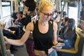 Caucasian female traveler using mobile phone on public transport metro in Kuala Lumpur,capital of Malaysia
