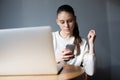 Caucasian female using messenger on cellphone. Hipster girl typing text on cell telephone