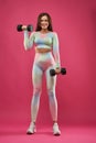 Caucasian fitness woman lifting dumbbell weights. Royalty Free Stock Photo