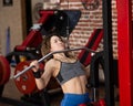 Caucasian forty-year-old woman doing lat pull-downs in the gym. Royalty Free Stock Photo