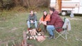 Caucasian friend around camping fire in the mountains