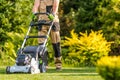 Garden Worker with Lawnmower Cutting Grass