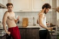 Beautiful gay couple in kitchen Royalty Free Stock Photo