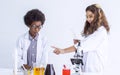 Caucasian girl and African black boy studying Science and doing experiment together in classroom at school. Education and Royalty Free Stock Photo