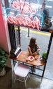 Caucasian girl in a coffee shop eating a cake