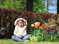 Caucasian girl with easter candy eggs in the palms on the lawn. Royalty Free Stock Photo