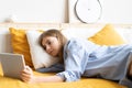 Caucasian girl having video chat with friends using tablet camera while lying on bed - technology, communication concept Royalty Free Stock Photo