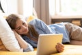 Caucasian girl having video chat with friends using tablet camera while lying on bed - technology, communication concept Royalty Free Stock Photo