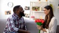 Caucasian girl holding tulips, present from afro-american male, anniversary gift