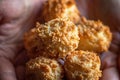 Caucasian girl holds in hands bunch of freshly home baked coconut puffs macaroons cookies. Christmas New years baking