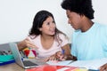 Caucasian girl learning with african american male student Royalty Free Stock Photo