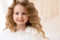 Caucasian girl with long curly white hair, brown eyes. human, child emotions. Royalty Free Stock Photo