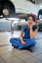 Caucasian girl mechanic working in the workshop