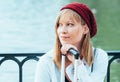Caucasian girl in a red beret, talking on the phone by the lake fence of the Parque del Retiro in Madrid, Spain Royalty Free Stock Photo
