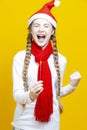 Caucasian Girl in Santa Festive Hat and Red Scarf Having Fun With Vivid Bright Burning Bengal Light Fireworks With Hand Lifted