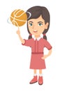 Caucasian girl spinning basketball ball on finger.