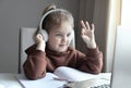 Caucasian girl studies online.Girl in headphones looking to laptop.The language of the dumb, finger spelling.Non-verbal